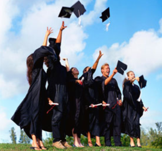 Graduates throwing their caps into the air